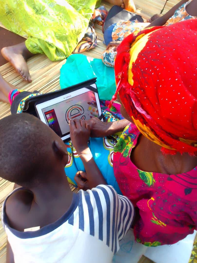 Grandmother and child learning together with a tablet