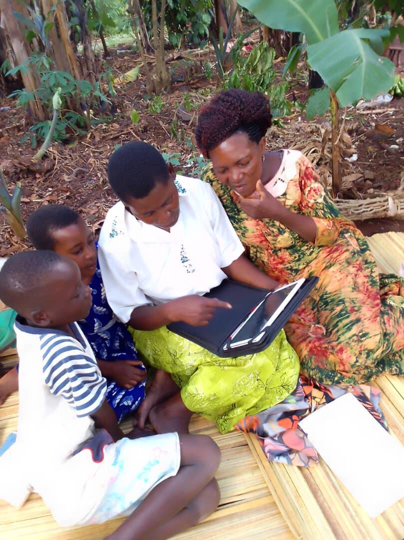 Grandmothers and children learning together using a tablet